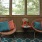 a room with a table chairs and a window with a view of trees